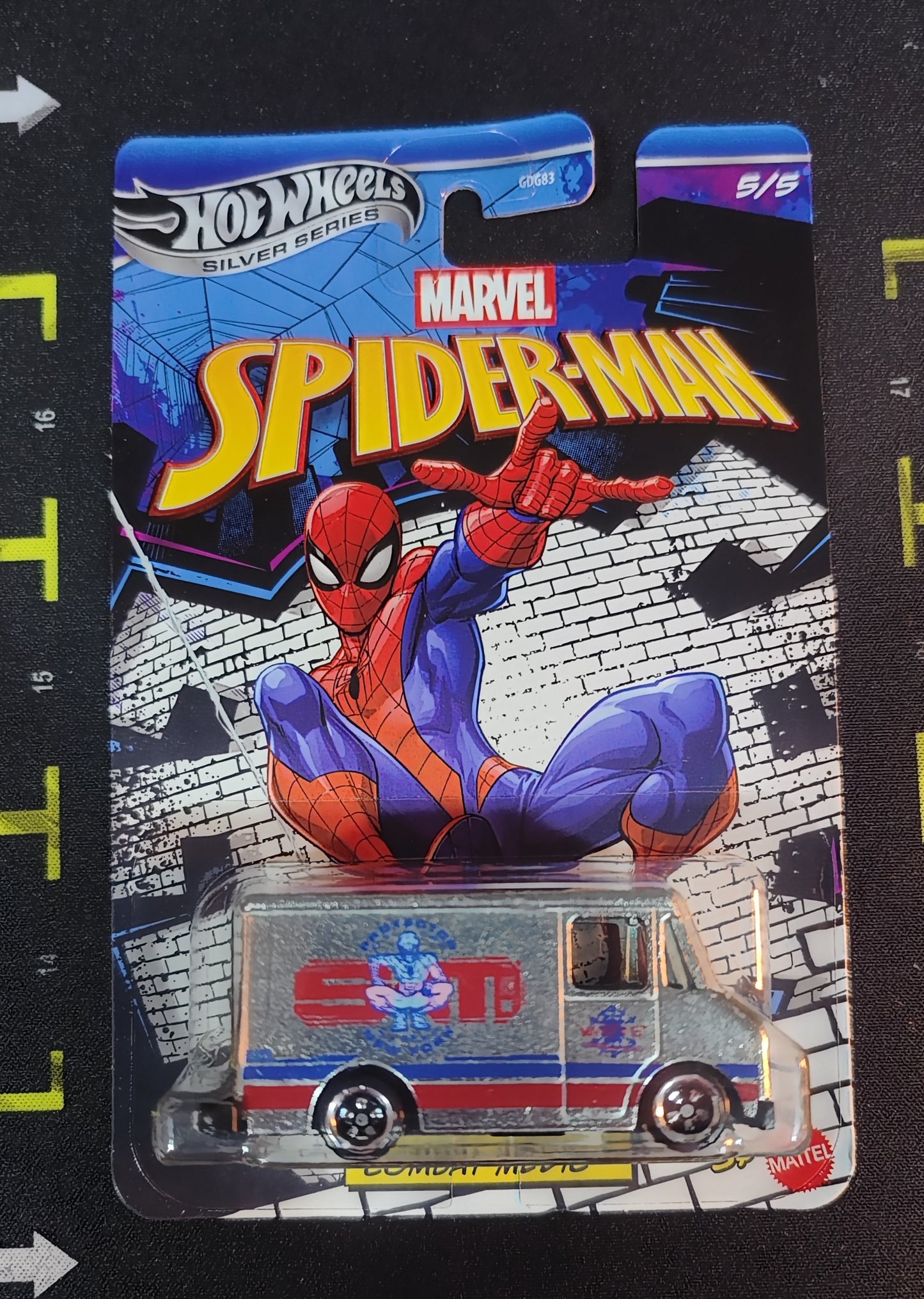 Hot Wheels Marvel Spider-Man toy car in packaging on a black background