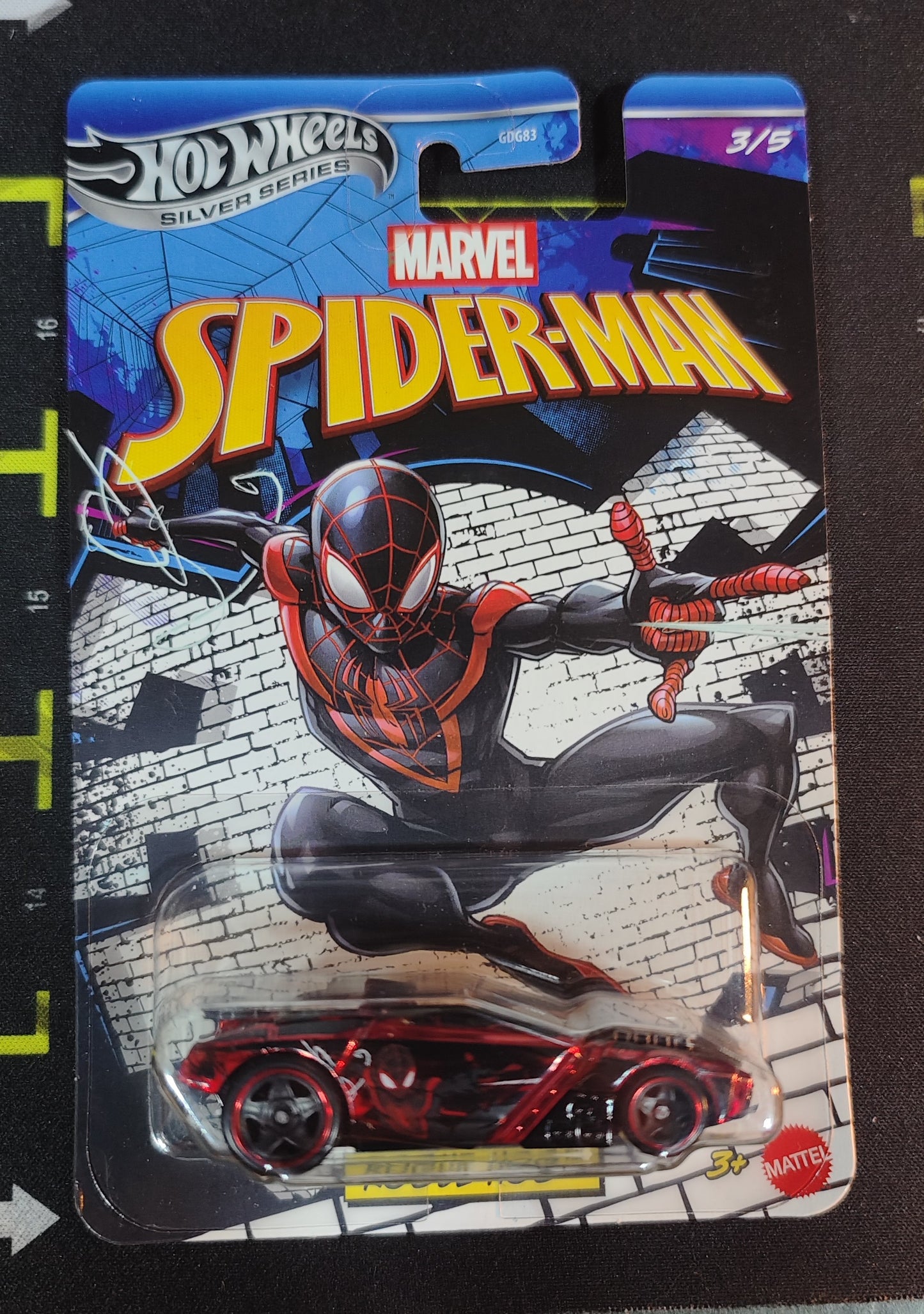Hot Wheels Marvel Spider-Man toy car in packaging on a black background