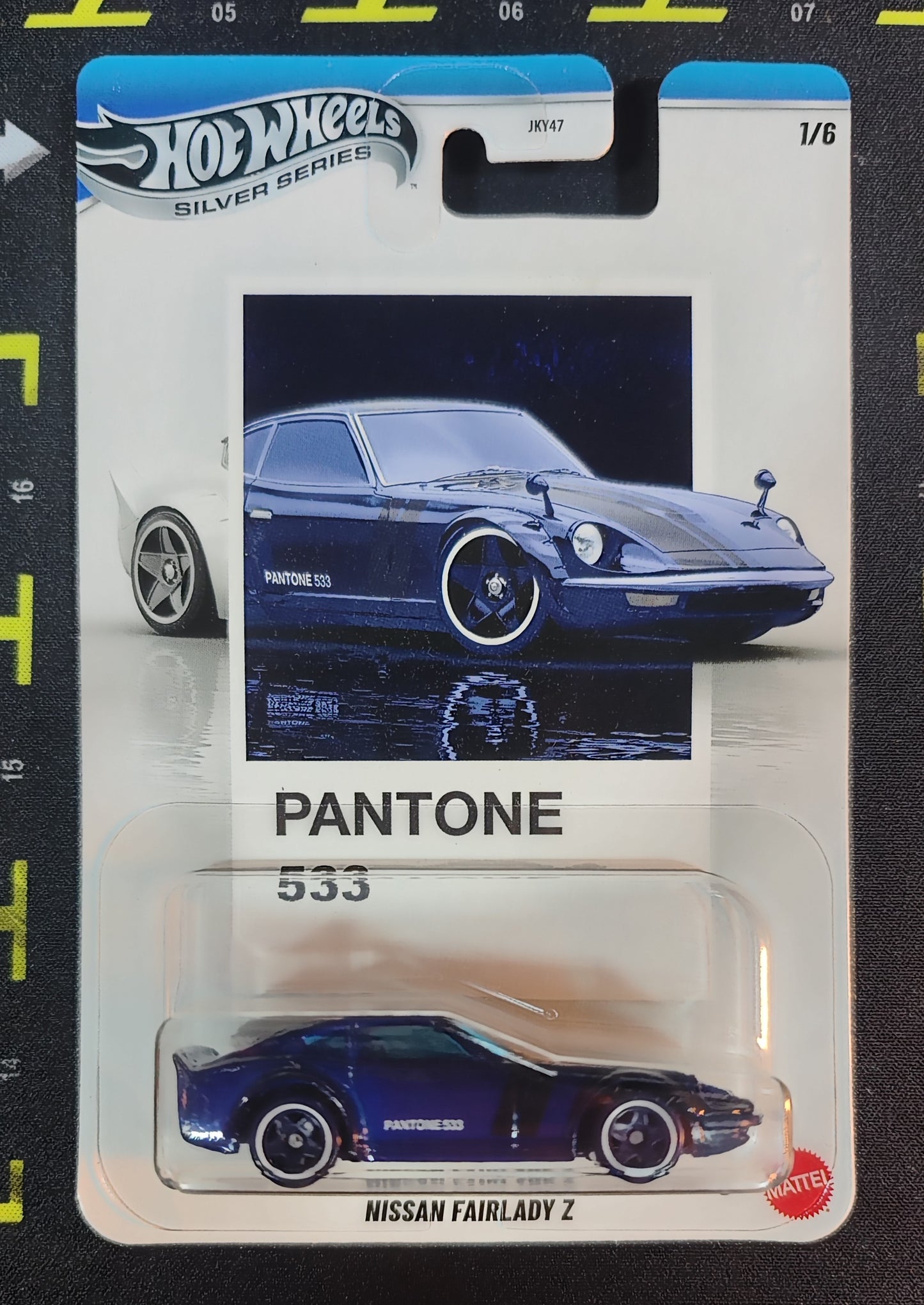 Hot Wheels Nissan Fairlady Z in Pantone 533 packaging with blue car on a black background