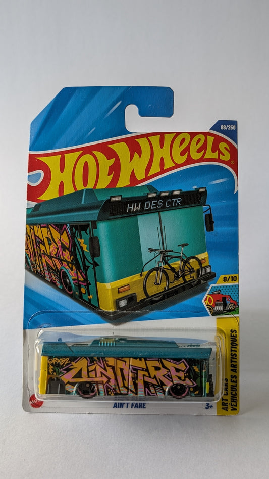 Hot Wheels toy car in packaging with graffiti design on a gray background