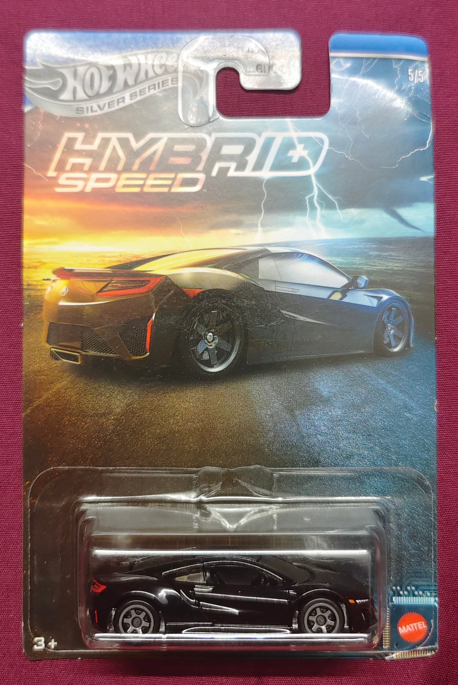Hot Wheels hybrid speed car model in packaging on a maroon background