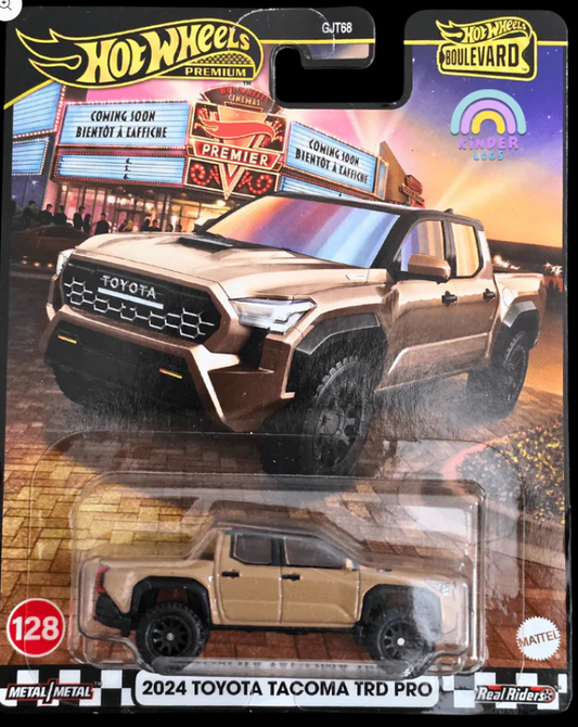 Hot Wheels 2024 Toyota Tacoma TRD Pro toy car in packaging with a cityscape background