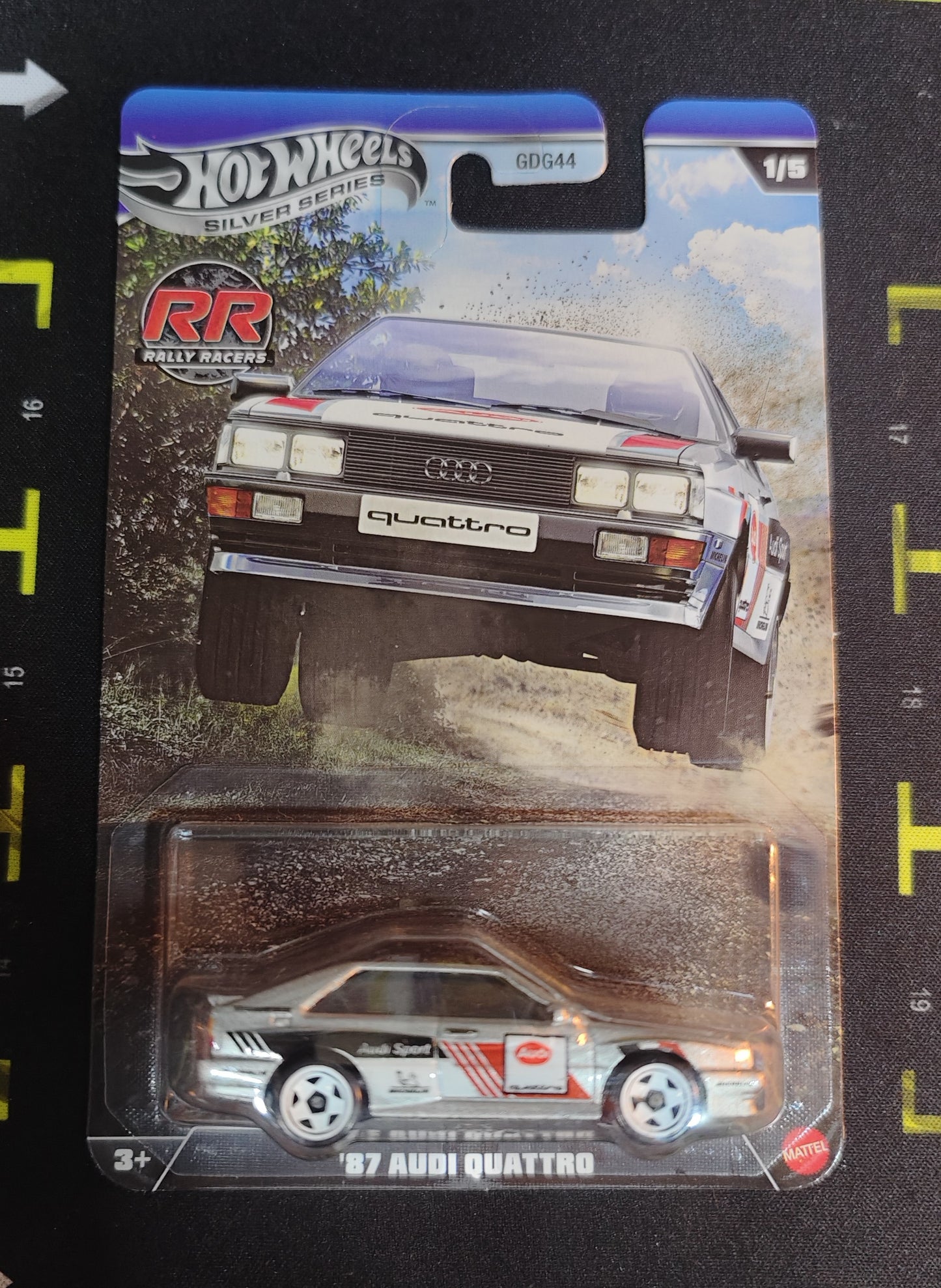Hot Wheels '97 Audi Quattro model car in packaging on a black surface