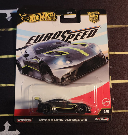 Hot Wheels Aston Martin Vantage GTE toy car in packaging on a striped background