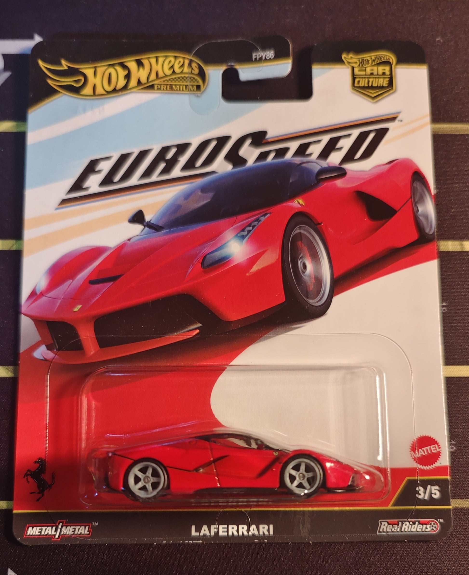 Hot Wheels Euro Speed LaFerrari toy car in packaging on a striped background