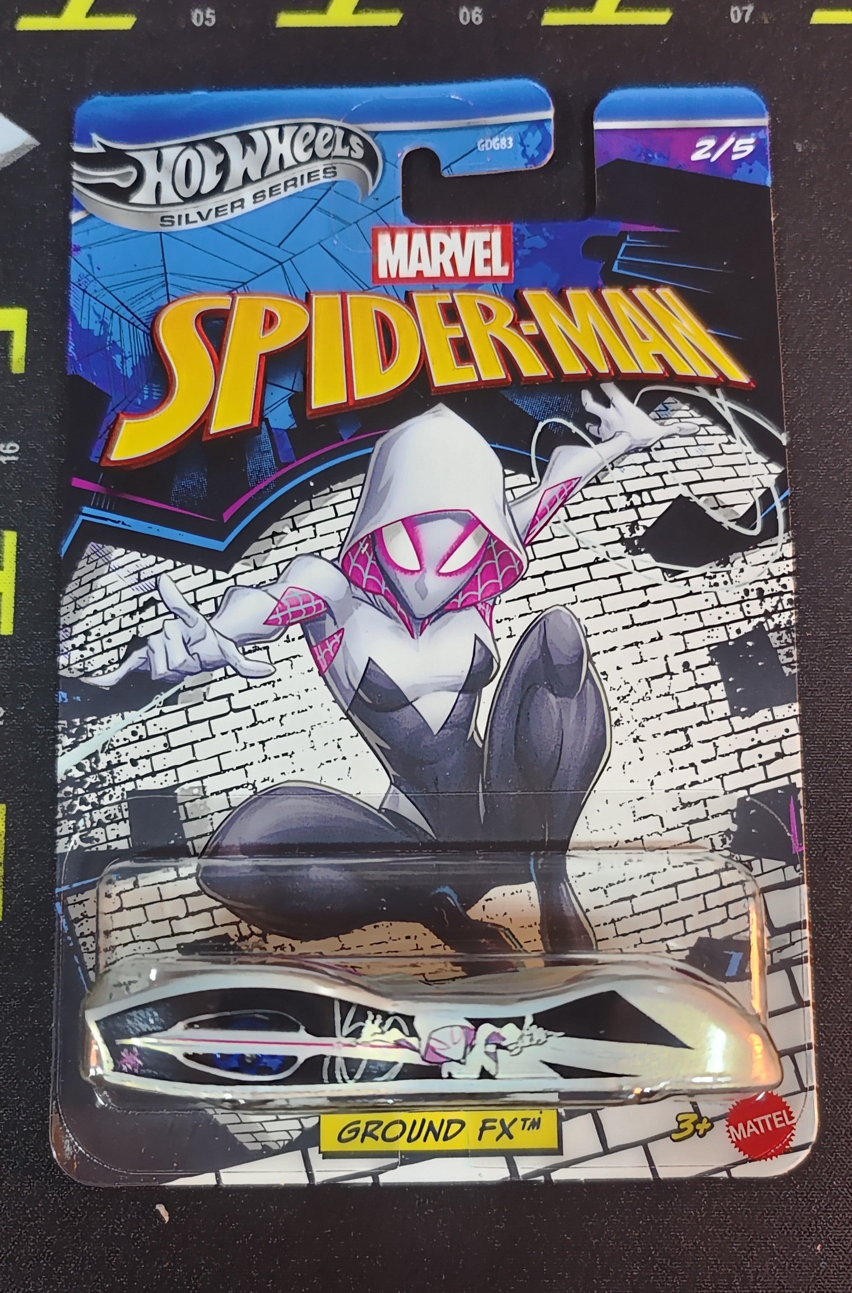 Hot Wheels Marvel Spider-Man toy figure packaging on a black background