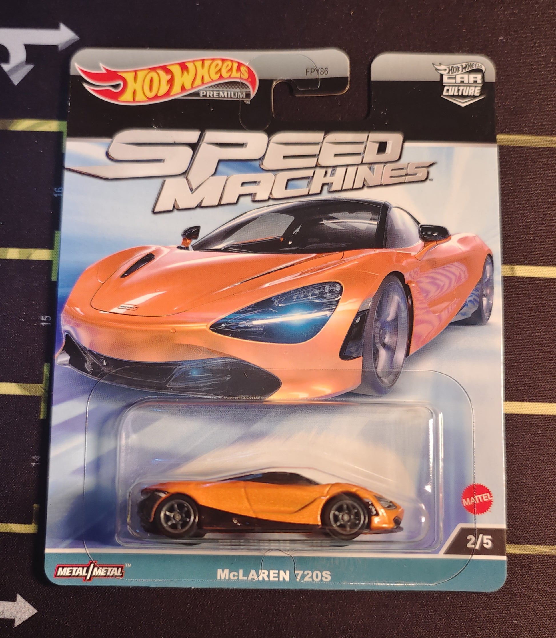 Hot Wheels McLaren 720S toy car in packaging on a dark surface