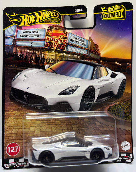 Hot Wheels car in packaging with a movie theater background