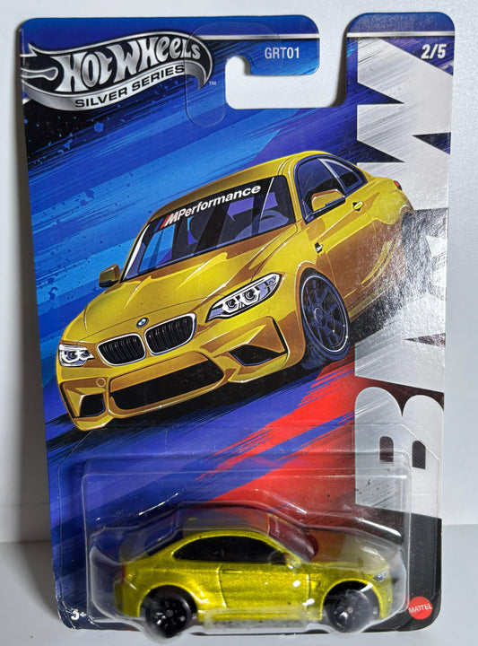 Hot Wheels yellow car in packaging on a white background Hot Wheels Silver Series BMW M2 Front view