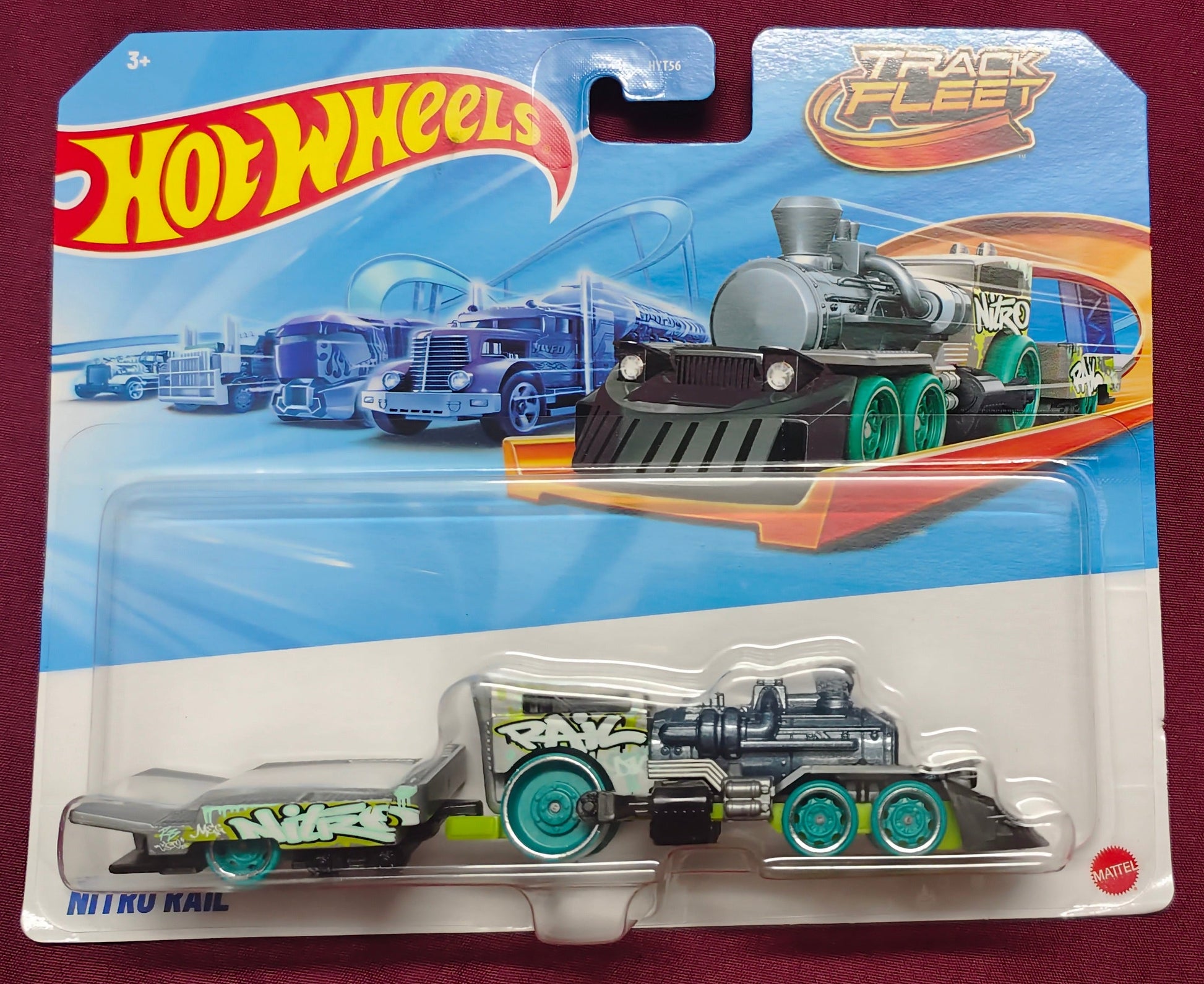 Hot Wheels train toy in packaging on a maroon background