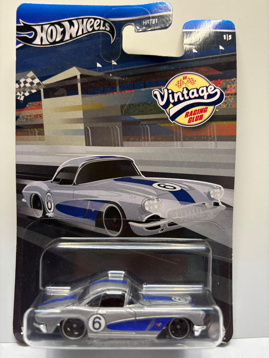 Hot Wheels vintage race car in packaging with a race track background