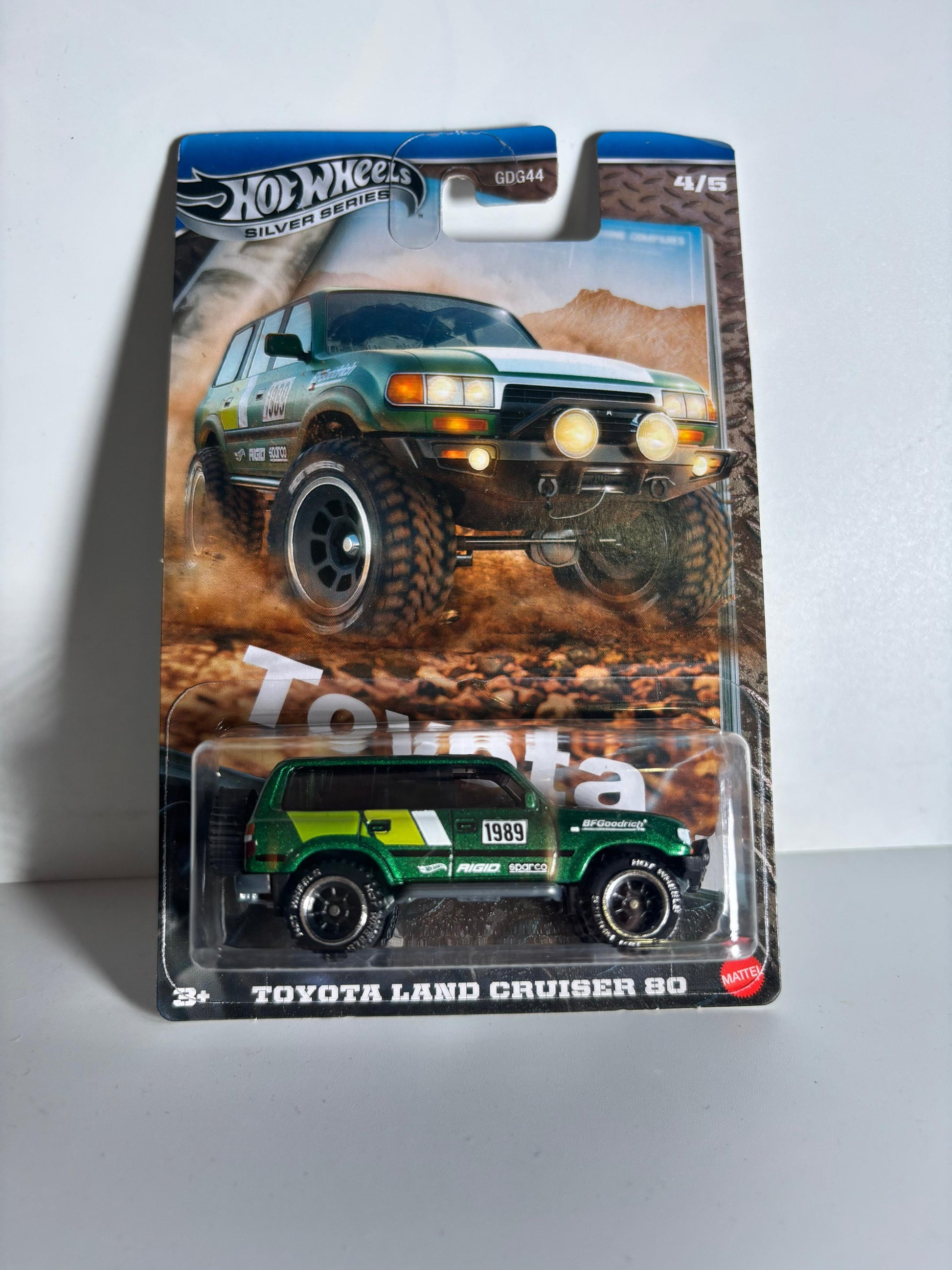 Hot Wheels Toyota Land Cruiser 80 toy car in packaging on a gray background