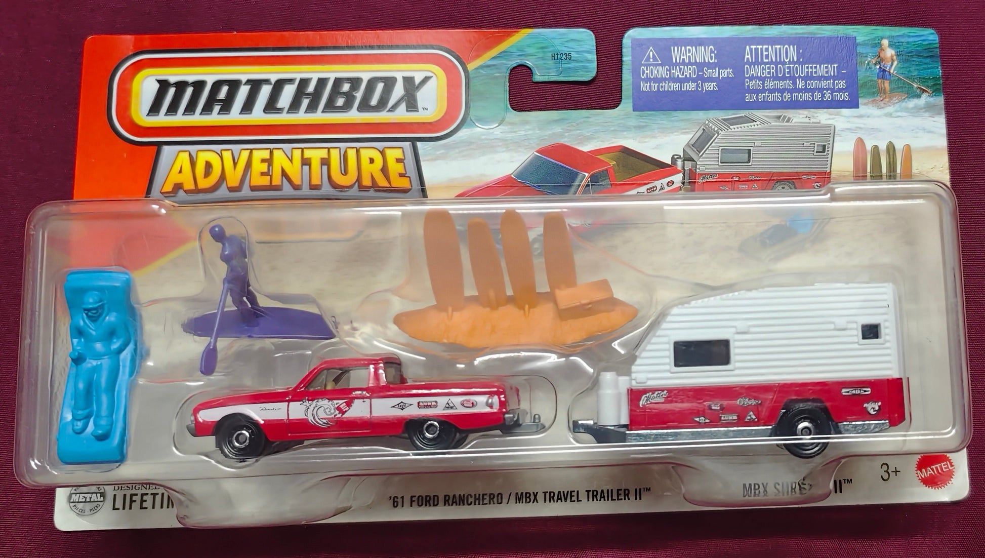 Toy vehicle in packaging on a maroon background