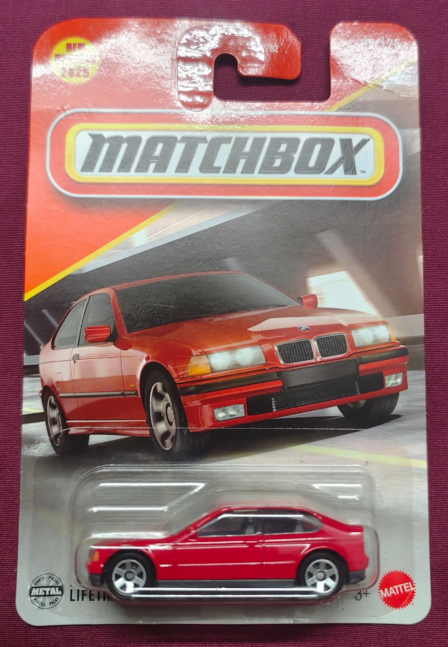 Matchbox toy car packaging with a red car on a purple background