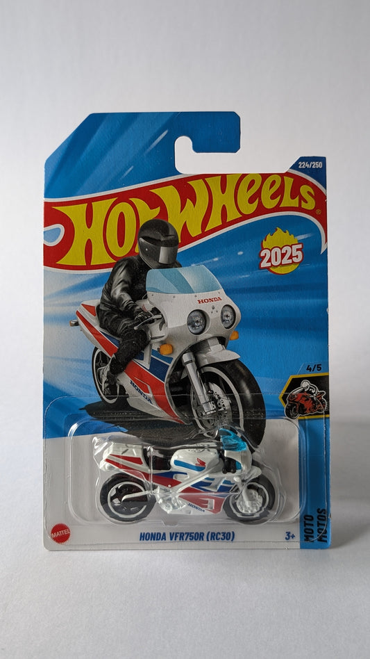 Hot Wheels motorcycle toy in packaging with '2025' branding on a gray background